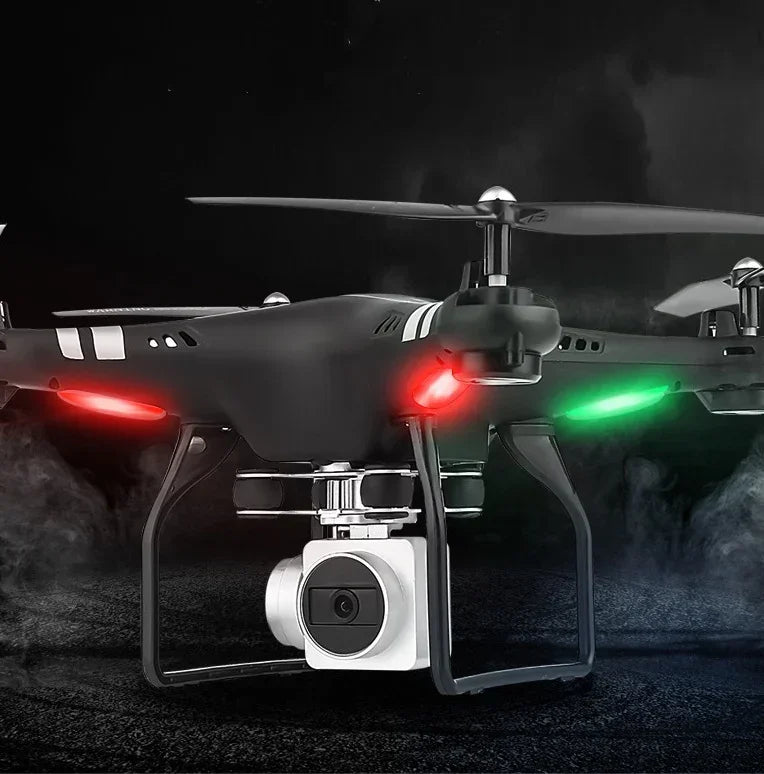 Black quadcopter drone with camera, LED lights, and sleek plastic body on a dark background