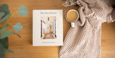 The Art of Home hardcover design book by Shea McGee on wooden table with coffee and beige blanket