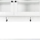 White wall-mounted shelf with cabinets, open shelves, and three metal hooks