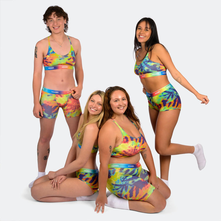Group of diverse women wearing colorful tie-dye Woxer Boss Bralettes and matching bottoms, showcasing wireless, seamless comfort and support
