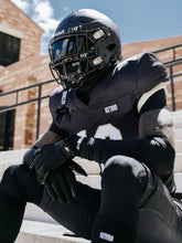 Athlete wearing black Nxtrnd Football Ski Mask cooling sports balaclava under helmet outdoors