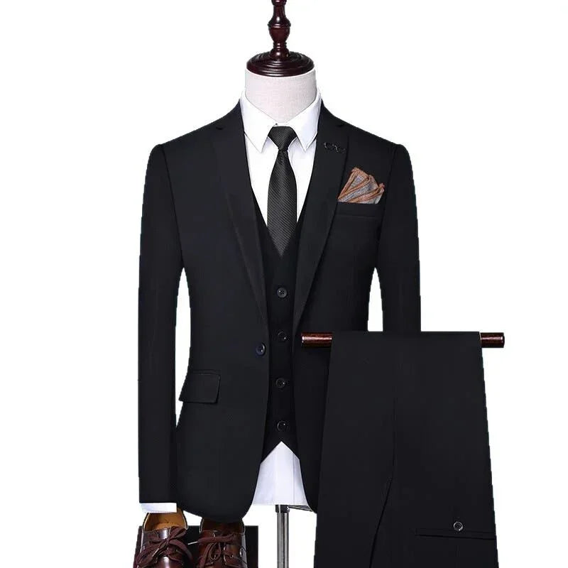Men's slim fit black three-piece suit with matching trousers and brown pocket square