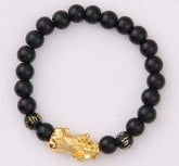 Black beaded bracelet with gold tone lion head accent, matte finish, unisex streetwear style