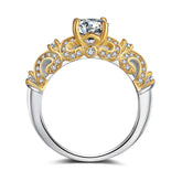 Gold and silver ornate ring with clear gemstone and filigree detailing