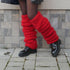 Chunky red knit leg warmers styled with black patent boots and sheer black tights
