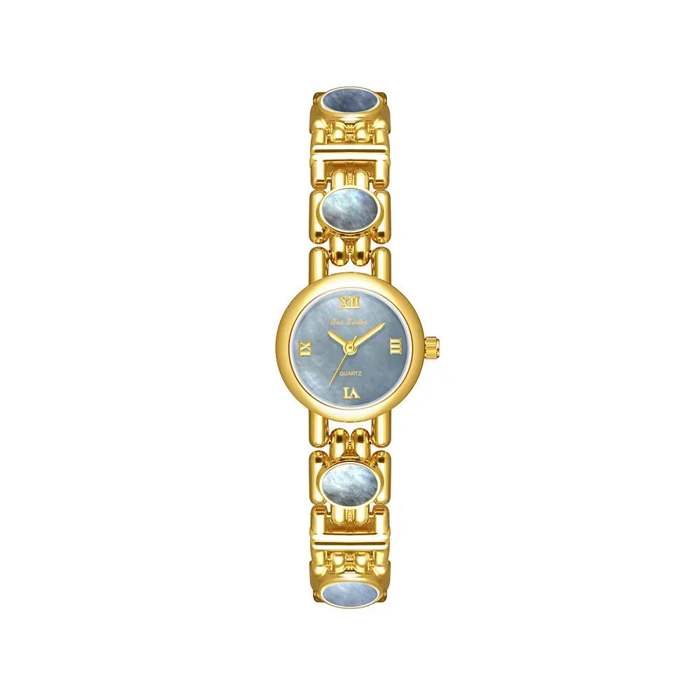Gold tone women's wristwatch with blue mother-of-pearl face and bracelet links