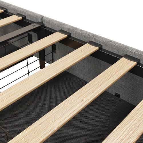 Close-up of light wood bed slats on metal frame with grey upholstered edge