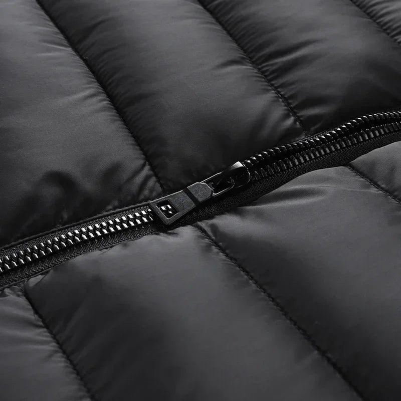 Close-up of black quilted puffer jacket with shiny zipper, smooth synthetic material