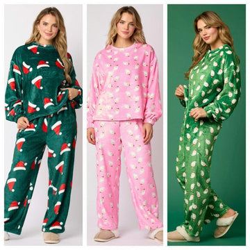 Women wearing plush fleece pajama sets in festive prints, relaxed fit, in green and pink.