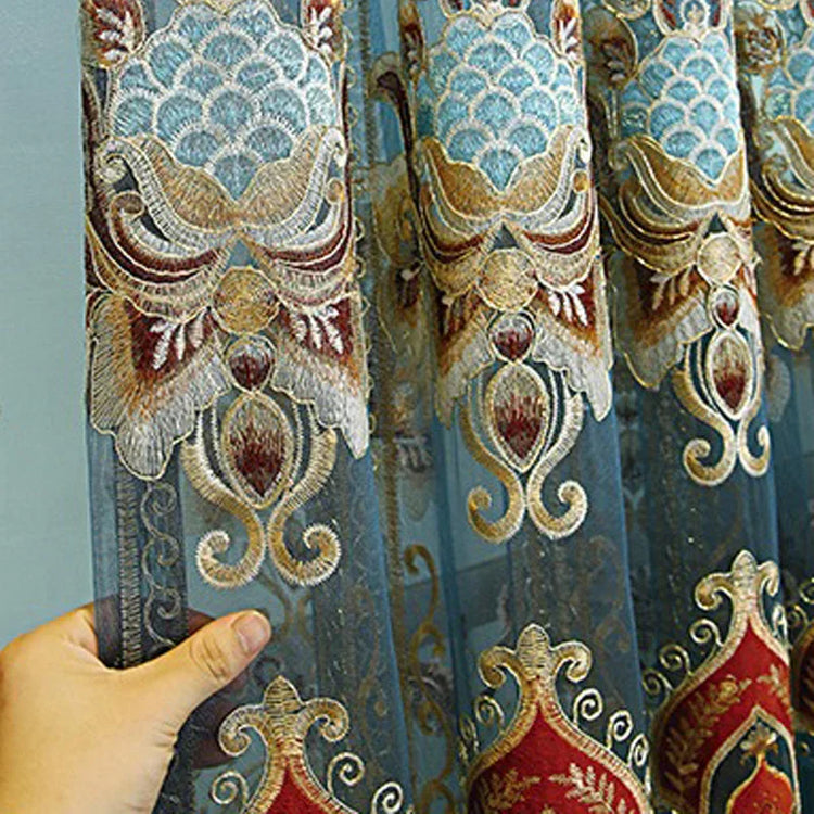 Blue and gold sheer fabric with ornate embroidered patterns, lightweight, elegant texture