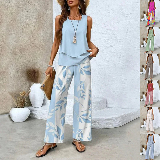 Woman wearing light blue sleeveless blouse and wide-leg leaf print pants, casual summer outfit.