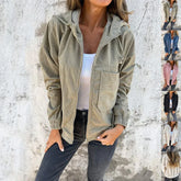 Woman wearing a relaxed fit khaki corduroy zip-up jacket with hood, paired with casual jeans
