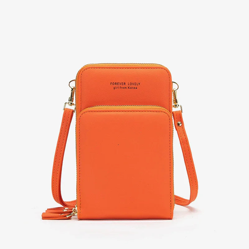 Vibrant orange faux leather crossbody bag with gold hardware and slim adjustable strap