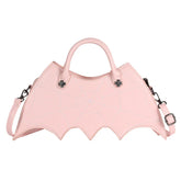 Pastel pink faux leather handbag with spider web stitching and batwing shape, detachable strap