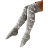Gray knitted over-the-knee socks with reindeer and snowflake patterns, winter cozy style.