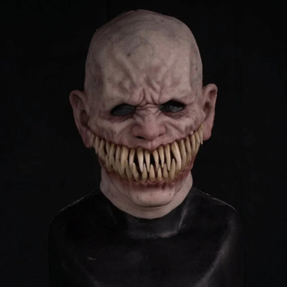 Scary horror mask with bald head, wrinkled pale latex skin, sharp teeth, black eye holes, close fit.