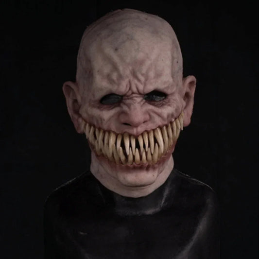 Scary horror mask with bald head, wrinkled pale latex skin, sharp teeth, black eye holes, close fit.