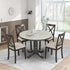 Modern dining room with a round marble-top table and four dark wood chairs with beige upholstered seats, set on a striped rug in a bright, airy space.