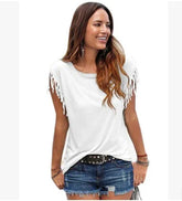 Woman wearing a white fringe sleeve top and blue denim shorts, casual streetwear fit