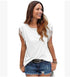 Woman wearing a white fringe sleeve top and blue denim shorts, casual streetwear fit