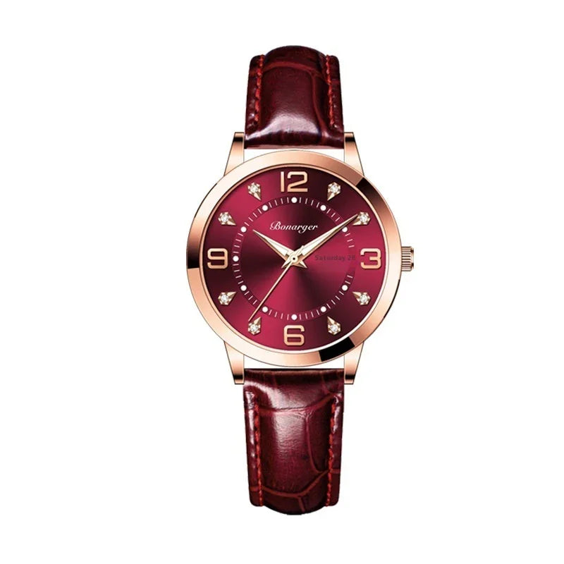 Burgundy leather strap watch with gold case, red dial, and crystal hour markers