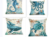 Set of decorative throw pillows with blue sea creature prints, featuring seahorse, octopus, whale, and turtle designs on textured fabric covers.