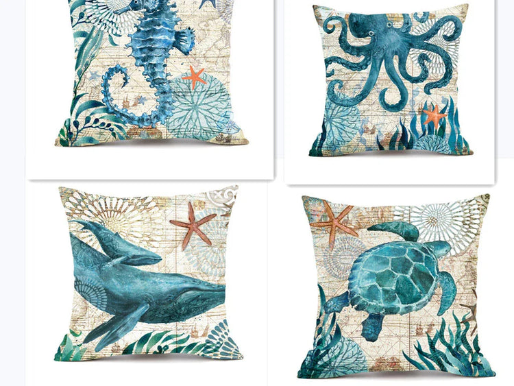 Set of decorative throw pillows with blue sea creature prints, featuring seahorse, octopus, whale, and turtle designs on textured fabric covers.