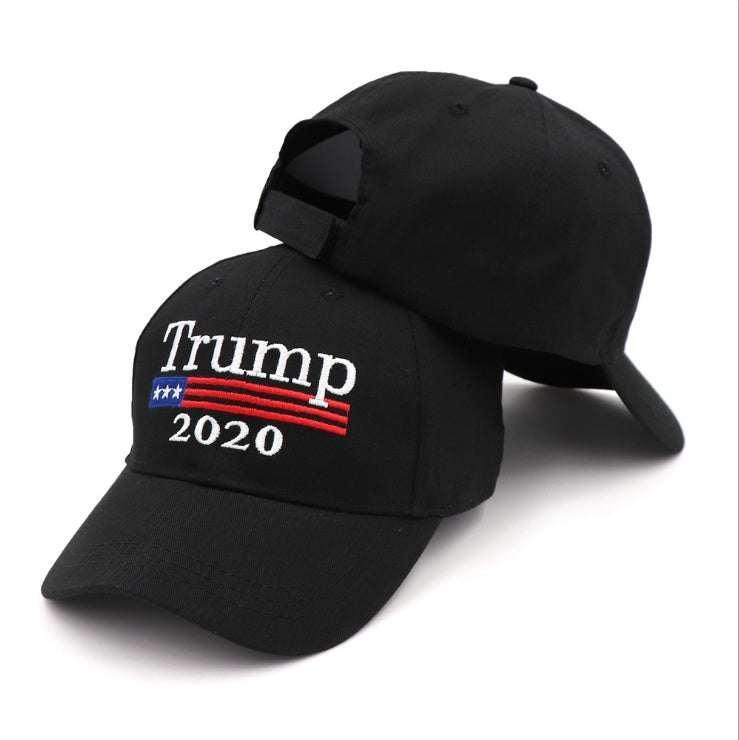 Black cotton baseball cap with curved brim, white embroidered text, and adjustable back strap