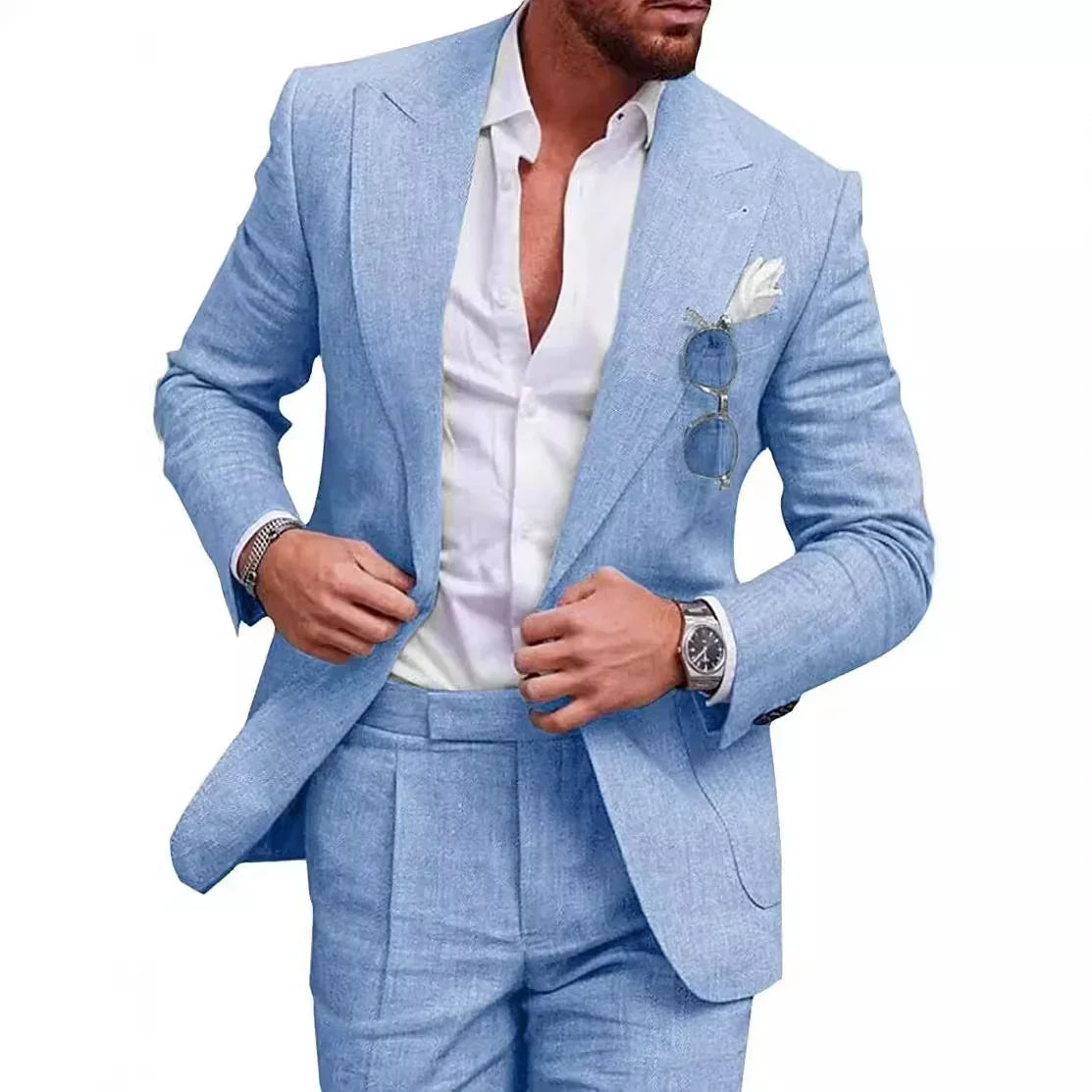 Man wearing light blue linen suit with a tailored fit, white dress shirt, and pocket square