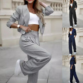 Women’s pinstripe suit set with cropped blazer, wide-leg pants, and ribbed white crop top in gray, black, and navy color options, relaxed fit, lightweight material.