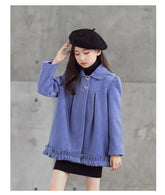 Girl wearing a loose-fit light purple coat with ruffle hem, black beret, and black dress.