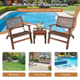 Outdoor brown woven rattan and wood patio chairs with matching side table by poolside