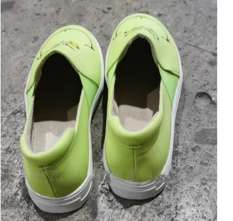 Lime green slip-on canvas shoes with cartoon face print, white soles, casual streetwear style