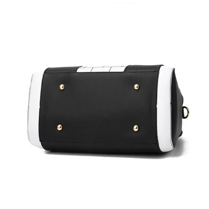 Black and white faux leather bag with gold studs and structured rectangular base