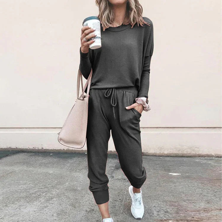 Woman in dark grey casual jogger set, relaxed fit, soft material, street style outfit