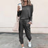 Woman in dark grey casual jogger set, relaxed fit, soft material, street style outfit