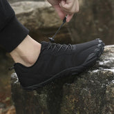 Black athletic outdoor sneaker with rugged sole and adjustable drawstring lace, slip-resistant fit