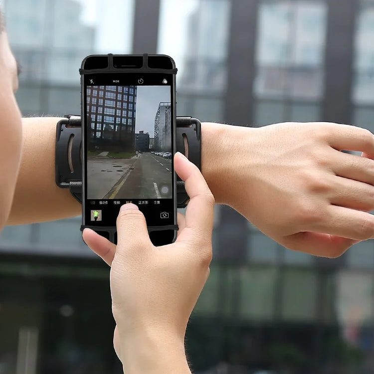 Black smartphone armband, adjustable fit, worn on forearm, street setting