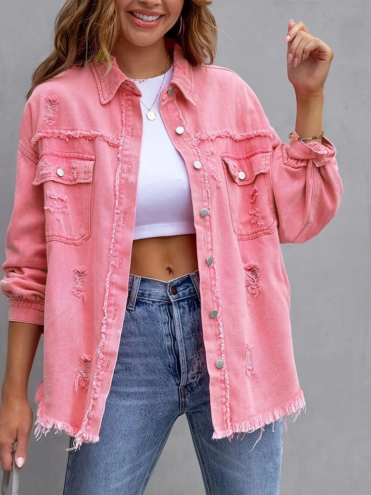 Woman wearing oversized pink distressed denim jacket, white crop top, and high-waisted jeans