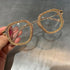 Gold-accented square eyeglasses with rhinestone trim, clear lenses, and oversized fit