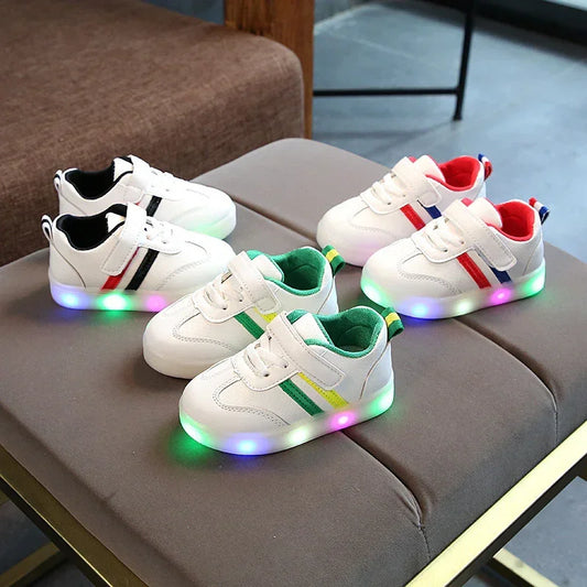 White kids' sneakers with colorful LED light-up soles, velcro straps, and multicolor accents.