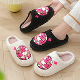 Cozy fleece slippers in black and white with pink and white embroidered pattern, slip-on style