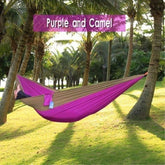 Two-tone purple and camel hammock, lightweight fabric, outdoor setting between palm trees