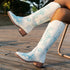 White knee-high western boots with blue floral embroidery, leather material, relaxed fit