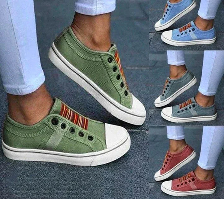 Casual slip-on canvas sneakers in green, blue, and red with white toe cap, striped detail, low-cut fit.