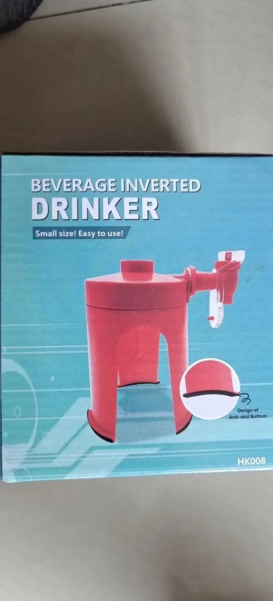 Red plastic inverted beverage dispenser with spout and anti-skid bottom, tabletop size