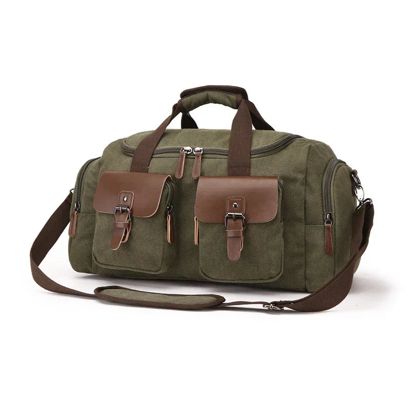 Olive green canvas duffel bag with brown leather accents, adjustable strap, and front pockets.