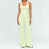 Woman wearing light yellow fitted tank top and wide-leg pants set, soft stretch fabric