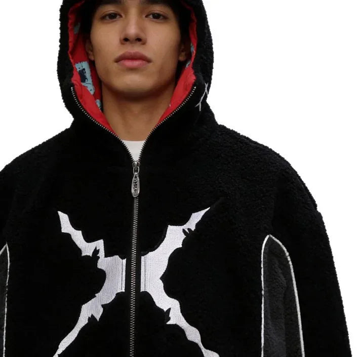 Man wearing black fleece zip-up hoodie with bold white graphic, relaxed streetwear fit