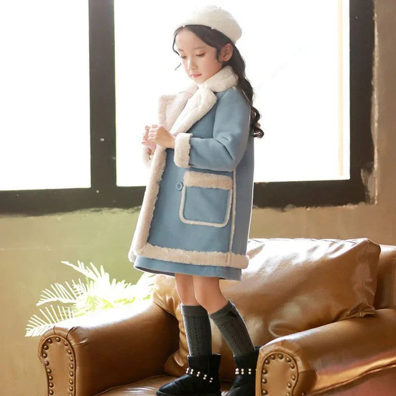 Girl in a light blue faux shearling coat with white trim, wearing a beret and winter boots